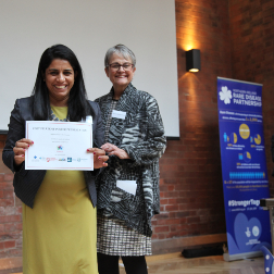 Dr. Suja Somanadhan receives poster VHC certificate.