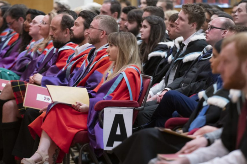 students sitting at graduation ceremony