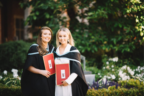 two female students on graduation day