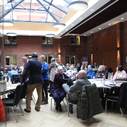 People conversing in busy conference room