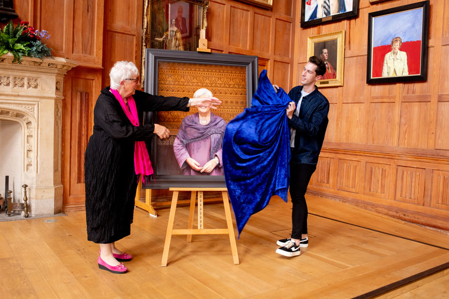 Ben Crothers and Carol McGuinness unveiling the portrait of Professor McGuinness in Queens Great Hall