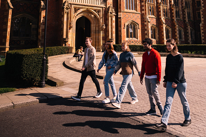 Group of students walking past the front of the Lanyon