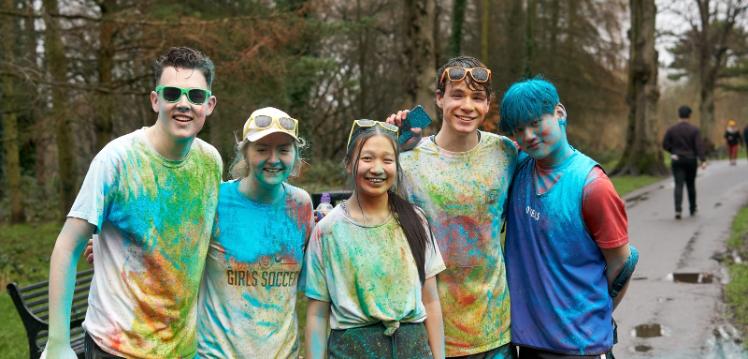 five smiling students from Queen's Cardiology Society after finishing the Colour Run 2022