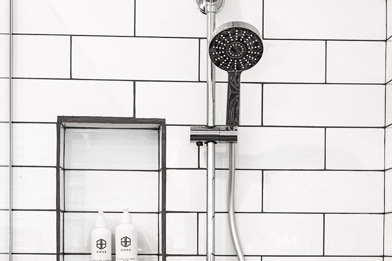 Shower-head and white tiles