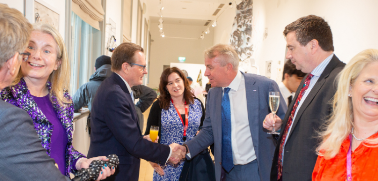 Queen's Vice-Chancellor shaking Neil Naughton's hand in Naughton Gallery