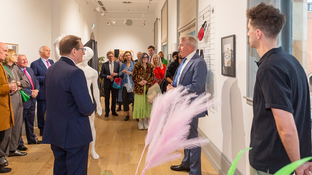 Neil Naughton welcomes guests to the Naughton Gallery's 20th anniversary exhibition