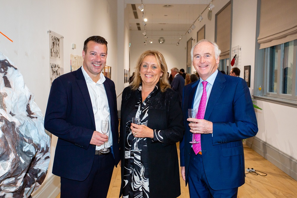 Anne McLaughlin and guests enjoying the Naughton Gallery's 20th anniversary exhibition