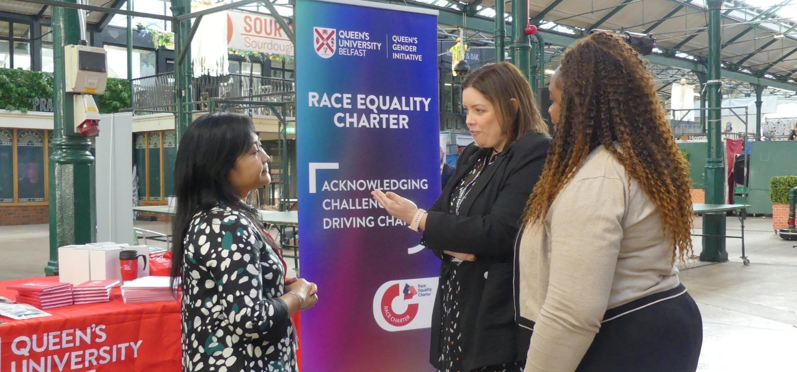 Adone Tielenius Kruythoff-Mohd Sarip talking with Minister Deirdre Hargey at the Black History Month expo, St George's Market