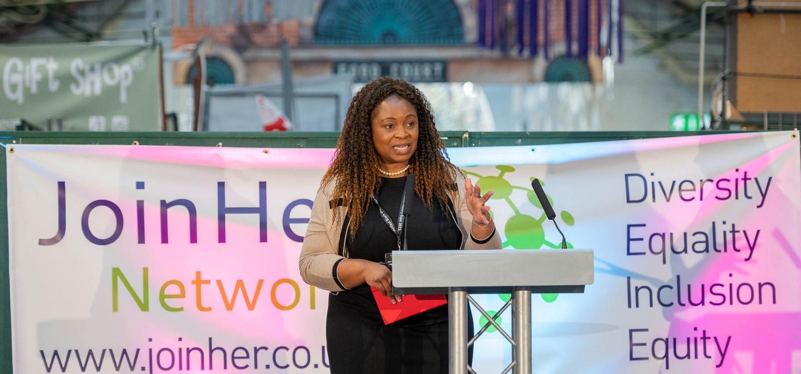 JustHer Network representative speaking at the Black History Month expo, St George's Market