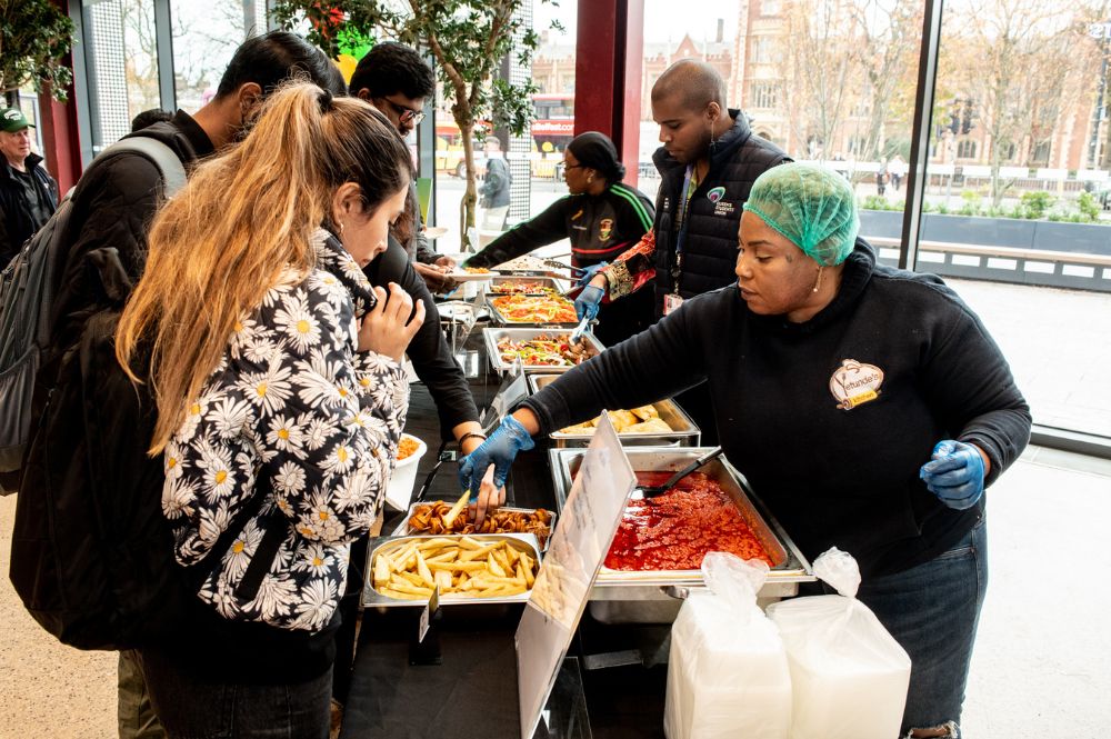 students being served Afro-Caribbean food