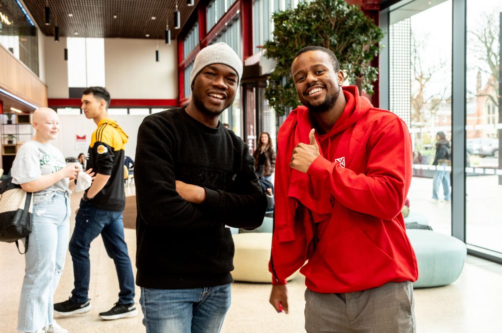 two black male students smiling to camera