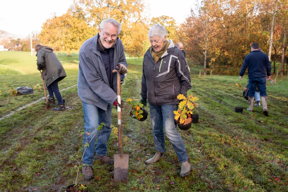 local resident volunteers helping to plant saplings at Malone Playing Fields