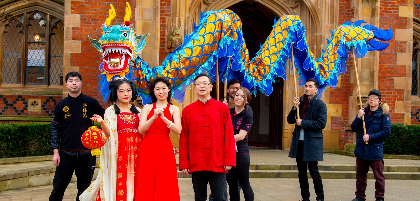 students, staff and local volunteers marking Chinese New Year 2023 outside Queen's Lanyon Building