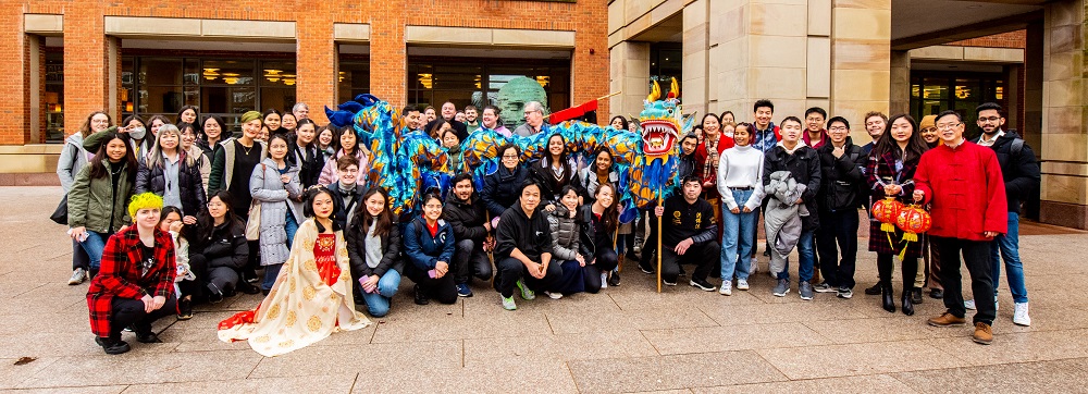 students, staff and local volunteers gathered outside the McClay Library, CNY celebrations 2023