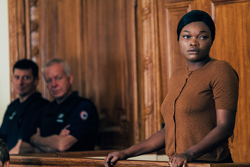 still from film Saint Omer, showing a black woman standing in the witness box in a court of law