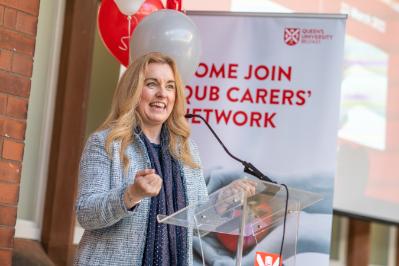 Image shows a female member of the Carers Network giving a talk at the Network launch in March 2022.