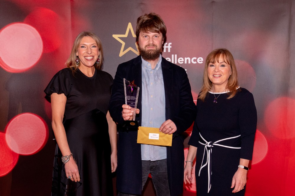 Neil Galway - Making and Impact Award winner (centre), with compere Alexandra Ford and Mairead Regan, Chair of the Staff Excellence Awards Judging Panel