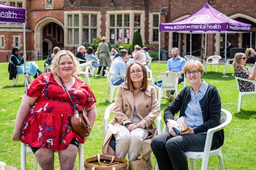 staff enjoying the sunshine and chat at the Great Big Purple Picnic in the quad during Mental Health Awareness Week 2023