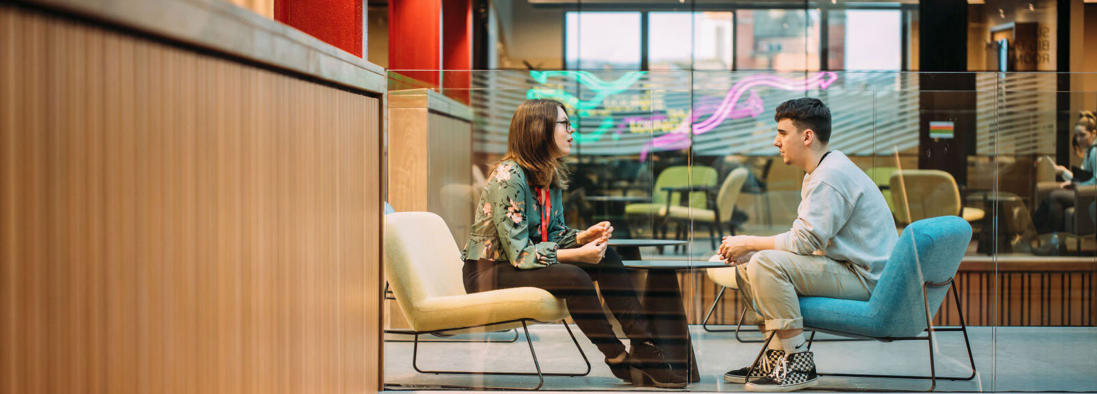 Student talking to a member of staff