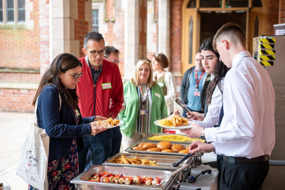 food being served at Queen's Carers Week barbecue on the quadrangle/cloisters, June 2023