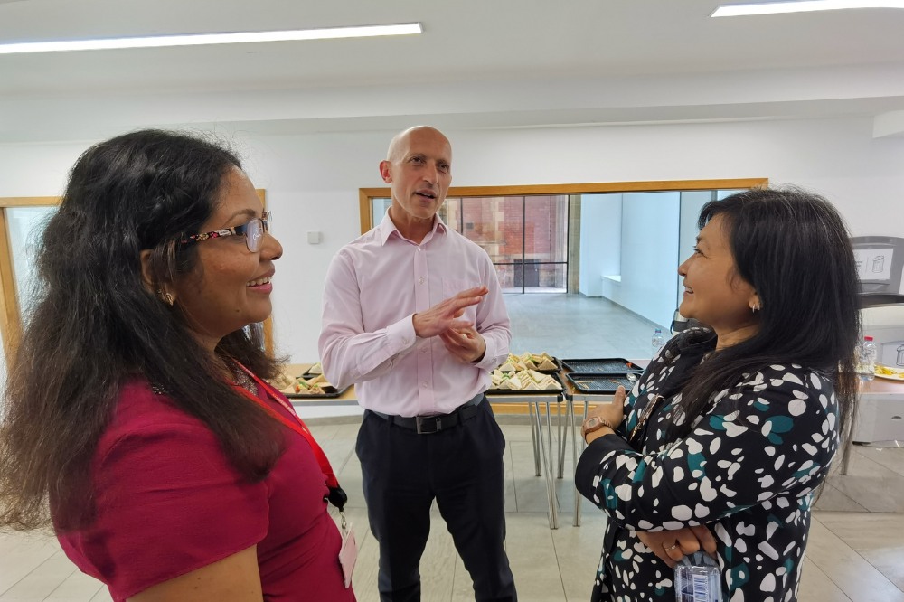 Queens staff members chatting at the Language Centre / iRise Summer Social and Wellbeing event, Peter Froggatt Centre