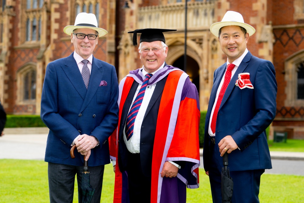 Jack Crane in graduation gown and guests wearing Panama hats