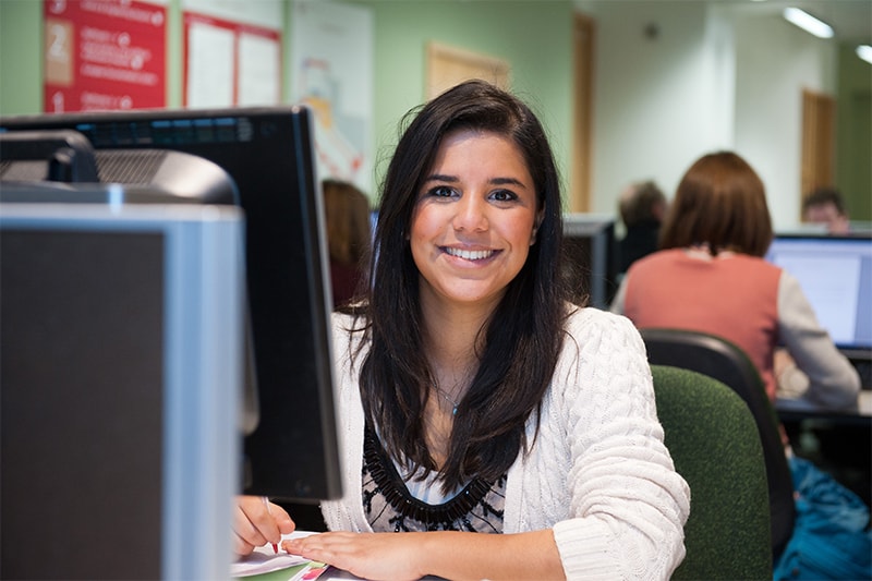 female student studying on a computer