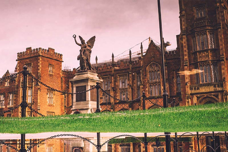 close up of Lanyon building and war memorial reflected in rain