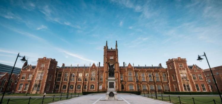 façade of Lanyon Building, Queens University Belfast, with bright blue sky overhead