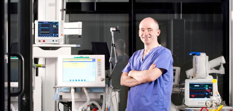 Professor Danny McAuley in scrubs in lab
