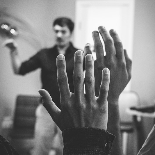 Image of two hands raised to ask a question