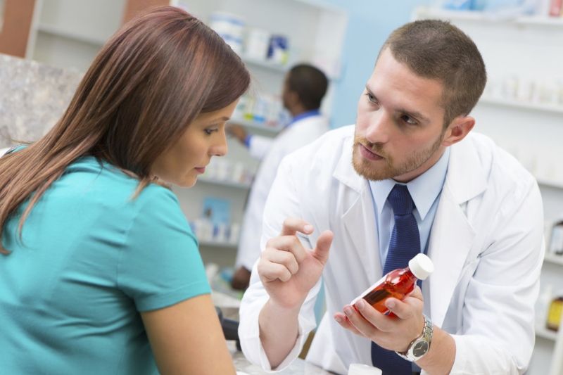 Pharmacist explaining something to a student
