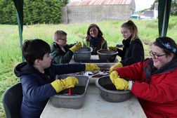 The Dig It! competition winners washing some of the finds