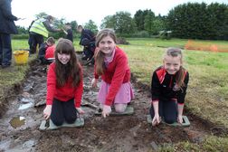 Primary school children excavating