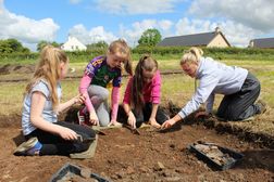 Primary school children digging at Fowler's Pottery
