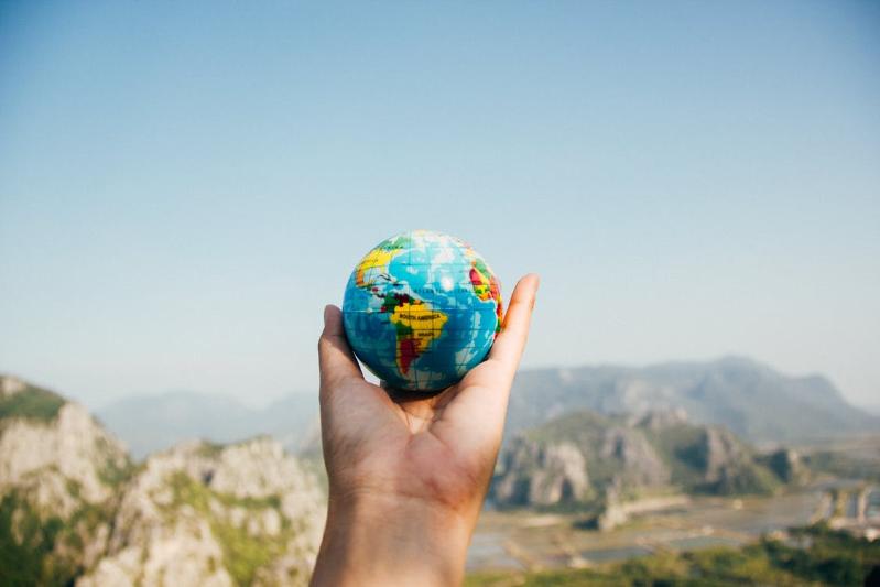 Hand holding a globe