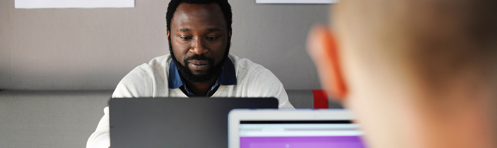 Staff member working at a laptop computer