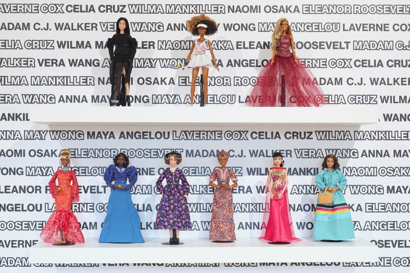 Images of Barbies on a shelf in different outfits