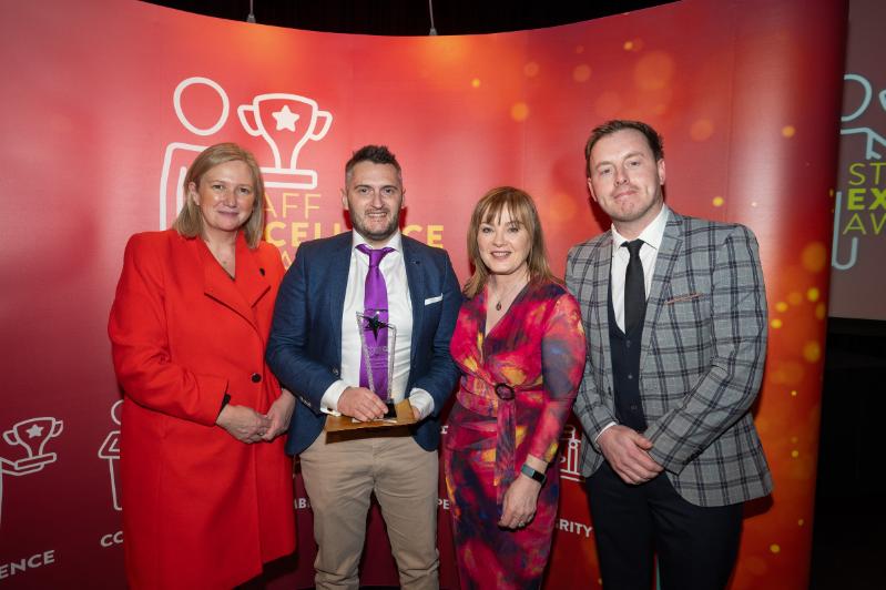 Image shows Co-Chairs of the Staff Excellence Awards Judging Panel, Gillian Magee and Mairead Regan, with winner Matthew Wilson and host Andrew Ryan.