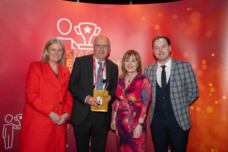Image shows Co-Chairs of the Staff Excellence Awards Judging Panel, Gillian Magee and Mairead Regan, with winner Professor Pascal McKeown and host Andrew Ryan