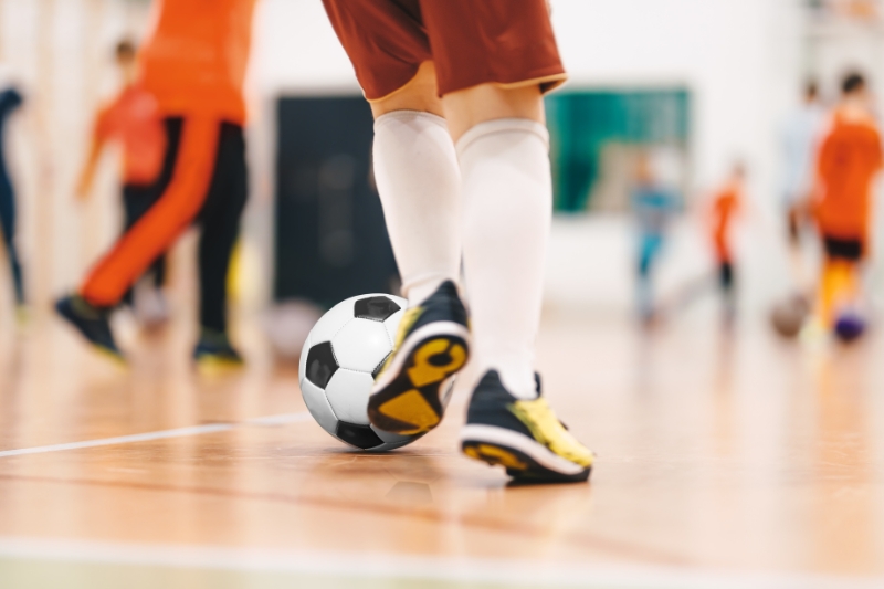 young people playing indoor football