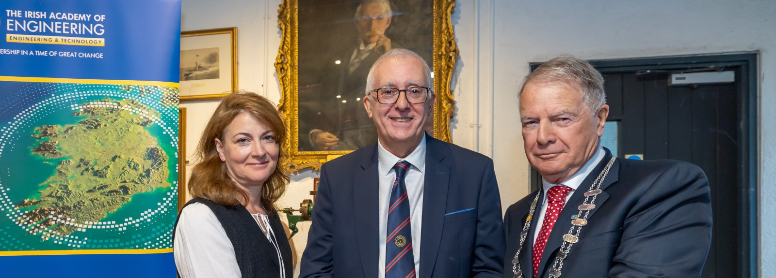 Professor Fusco proudly holding his award medal, smiling, after receiving it from the IAE.