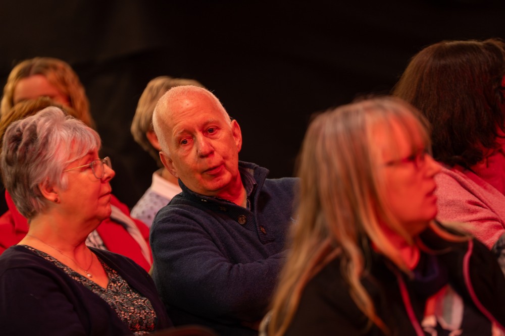 seated people chatting at an indoor event