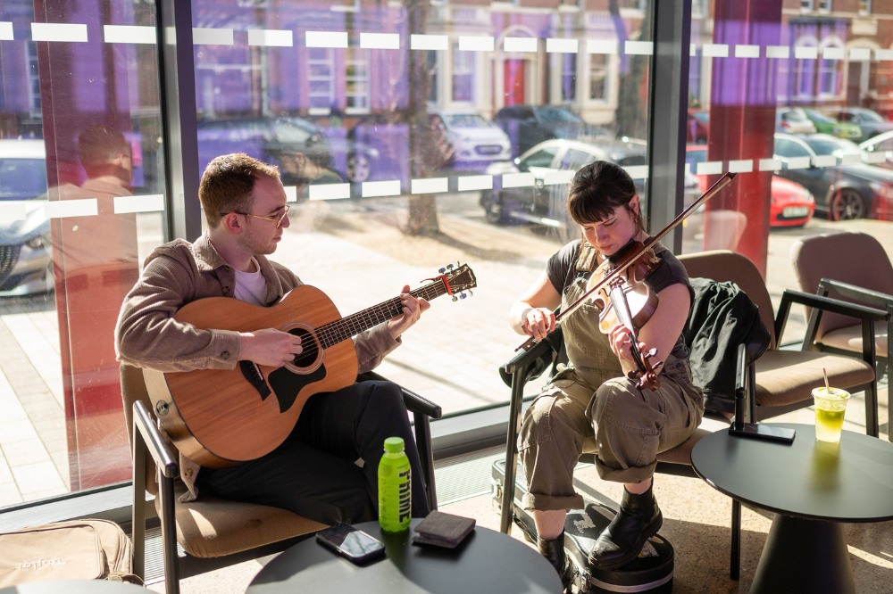 two musicians playing outside Mandela Hall at the Staff Excellence Awards 2022-23 reception